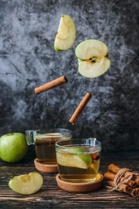 Pieces of apples merged in water in preparation of apple cider vinegar